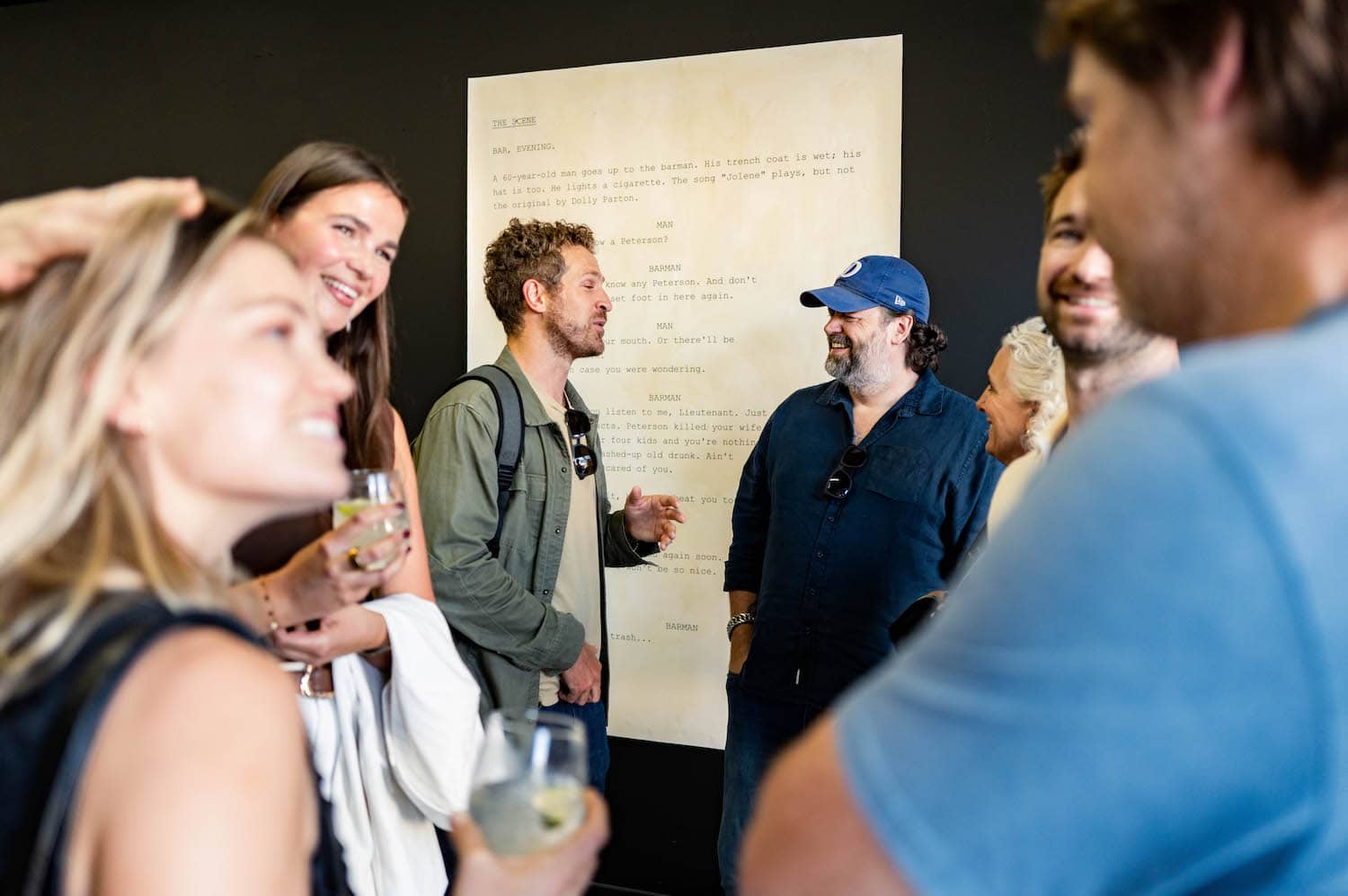 Visitors talking in front of the printed script page