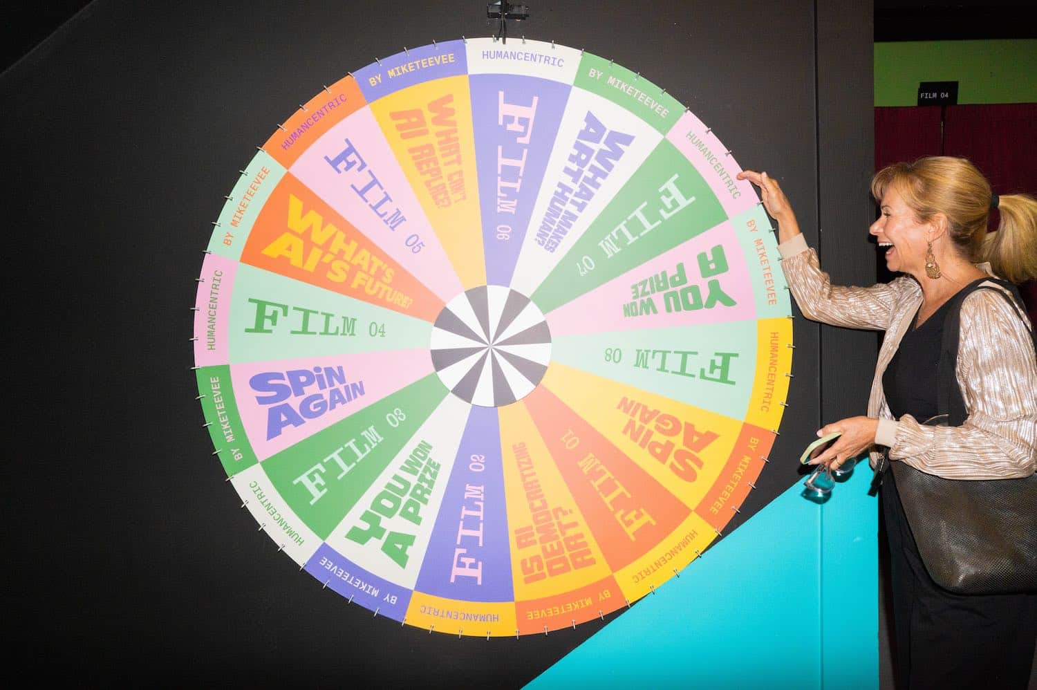 A visitor spinning the Wheel of Fortune, its segments naming the eight films