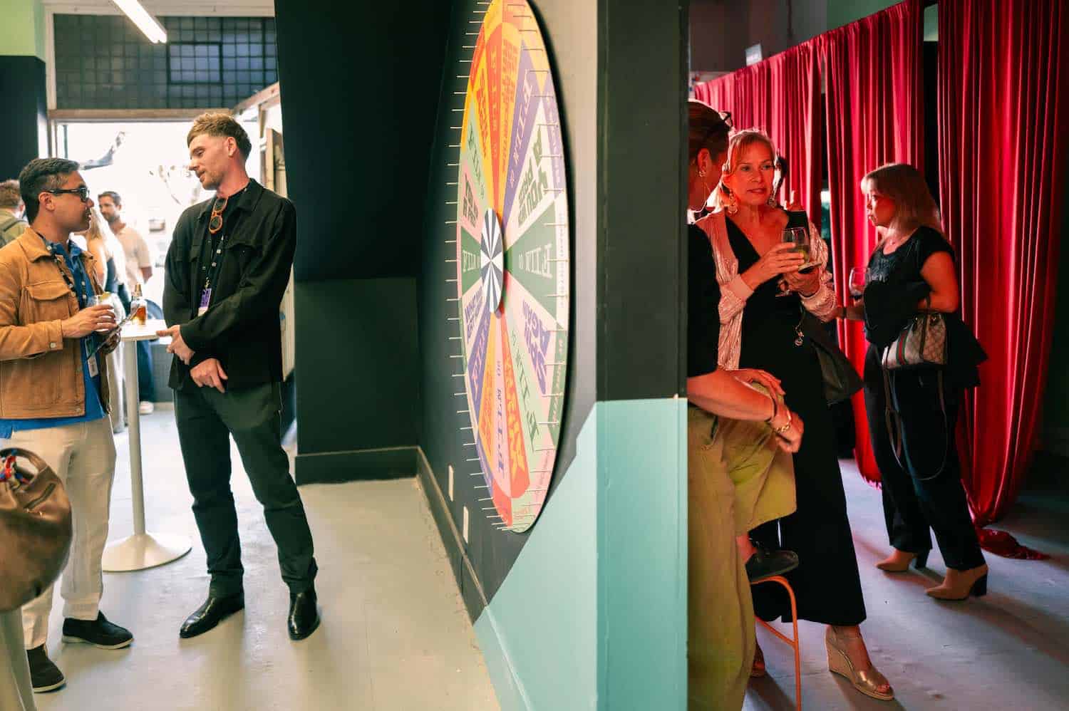 The gallery: the Wheel of Fortune on one side, the red curtained viewing booths on the other